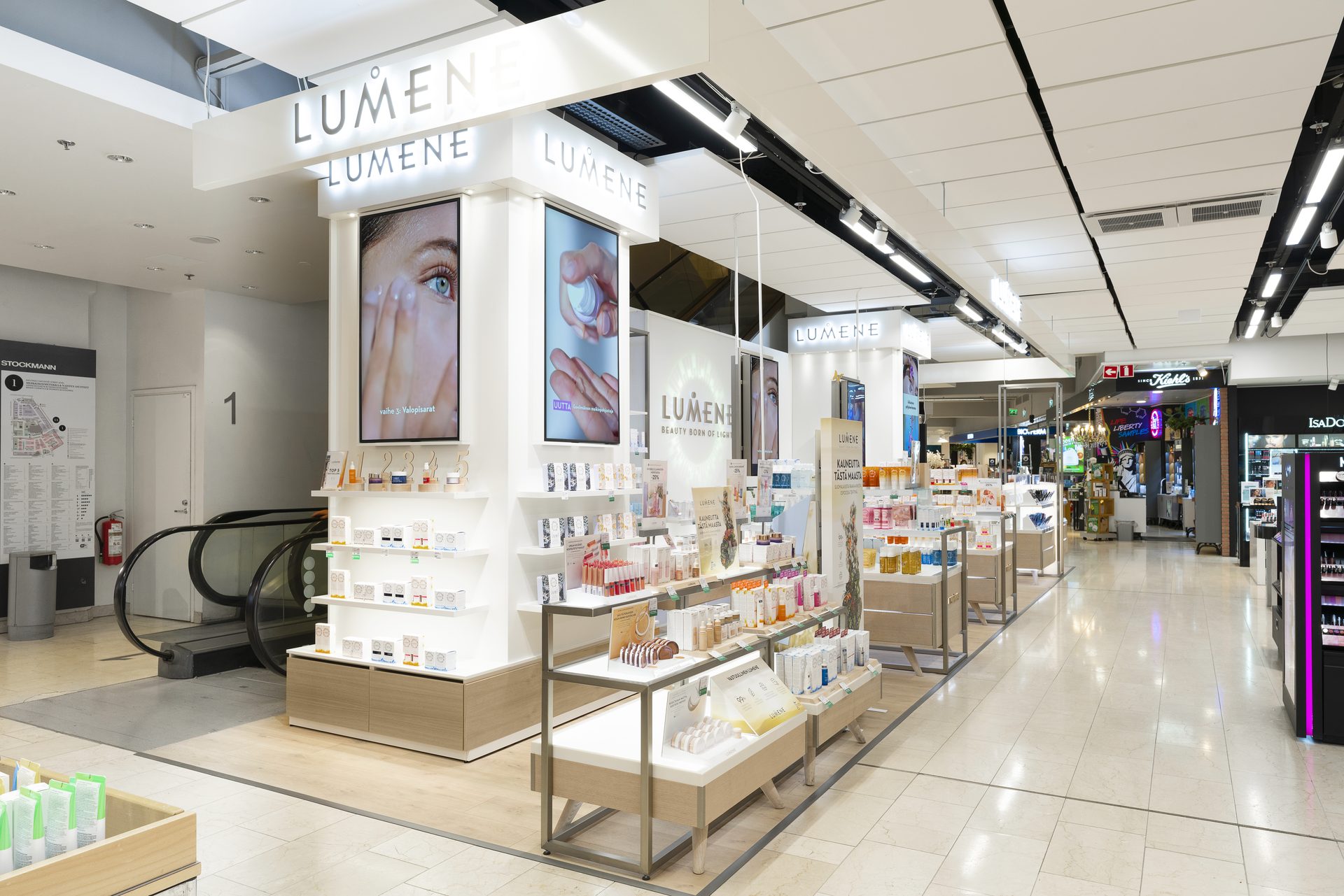 Two adjoining Lumene kiosks in a department-store aisle