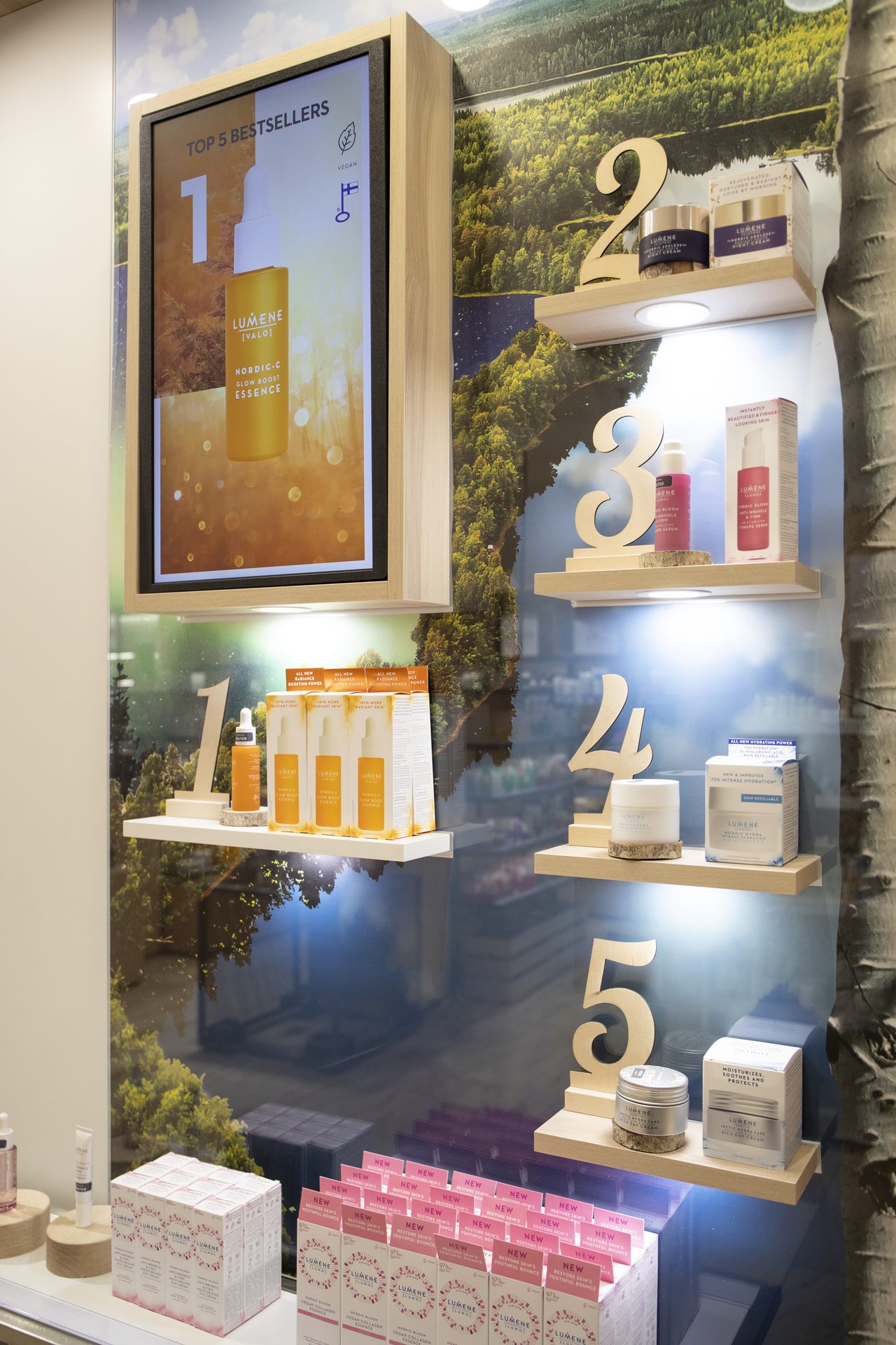 Vertical digital shelf-edge screen showing Top 5 Bestsellers over a forest backdrop