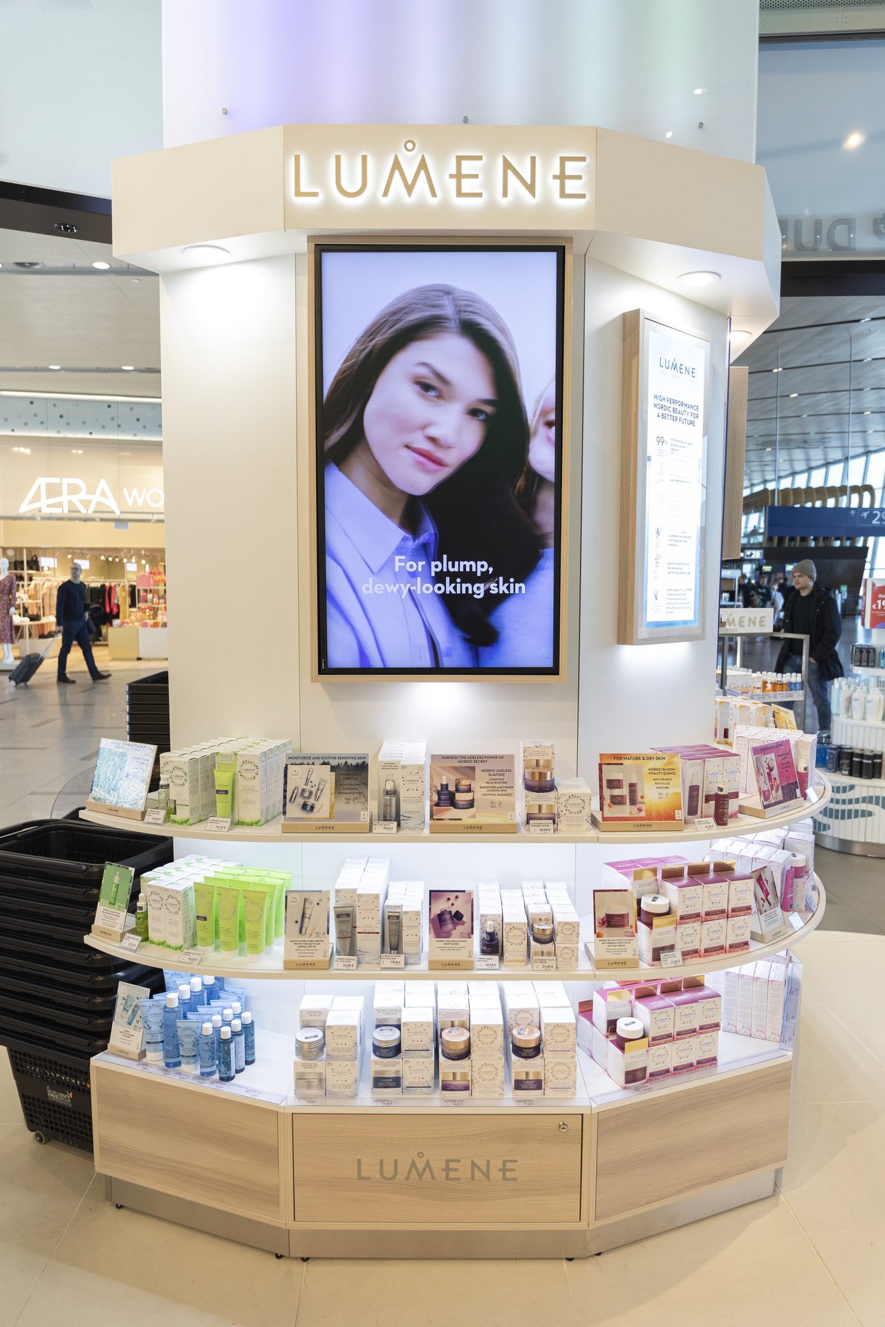 Curved kiosk digital screen with product shelving fanning out below