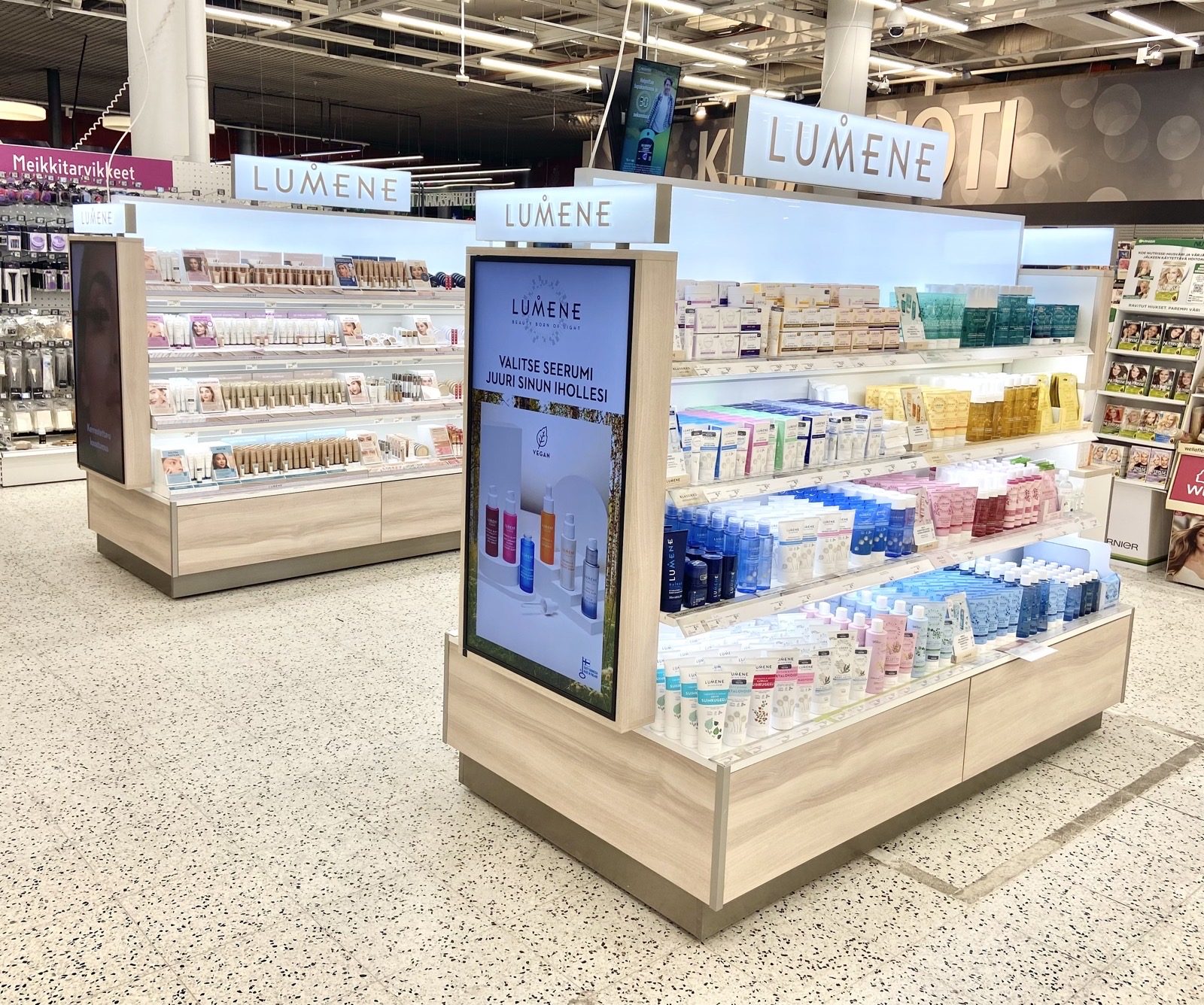 Grocery-store Lumene shelf bay with digital serum screen