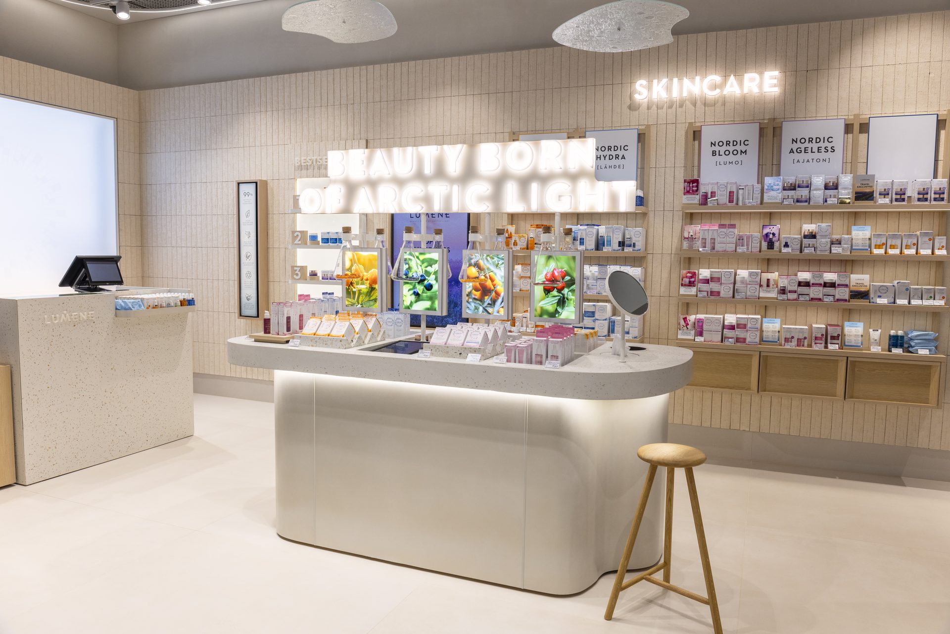 Lumene airport store interior, curved counter and birch shelving